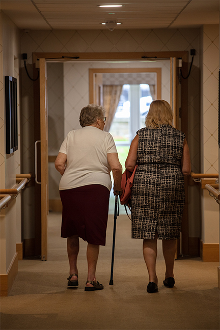 Resident and Loved One Walking Down Hall