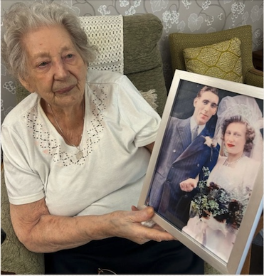 resident holding image of her wedding day