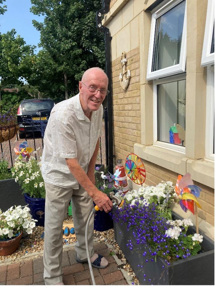 one of our residents watering the flowers