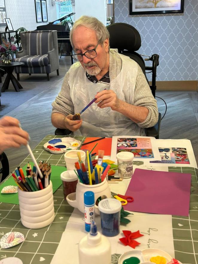 resident painting pine cone