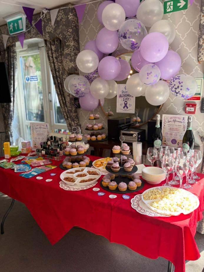 table with balloons, cakes and other food and drink