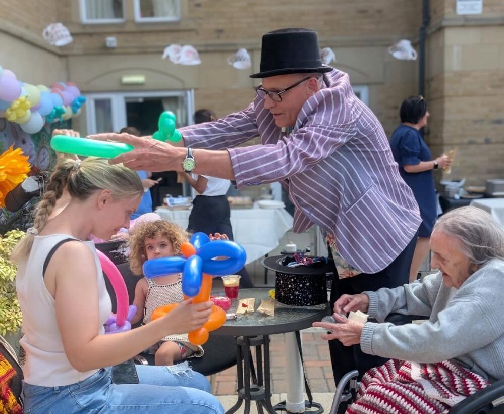 family members with colourful balloon hats