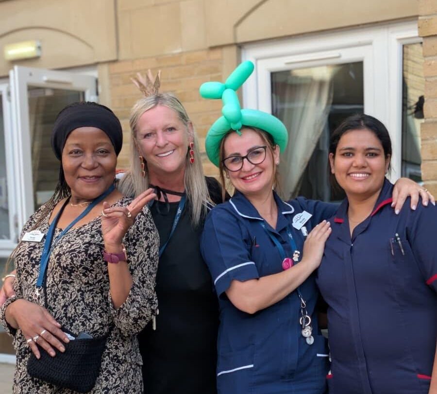 staff smiling at alice in wonderland event